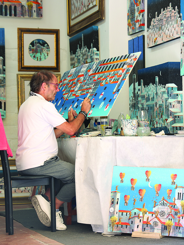 Cortona artist paints with open doors in the town square for everyone to enjoy. 